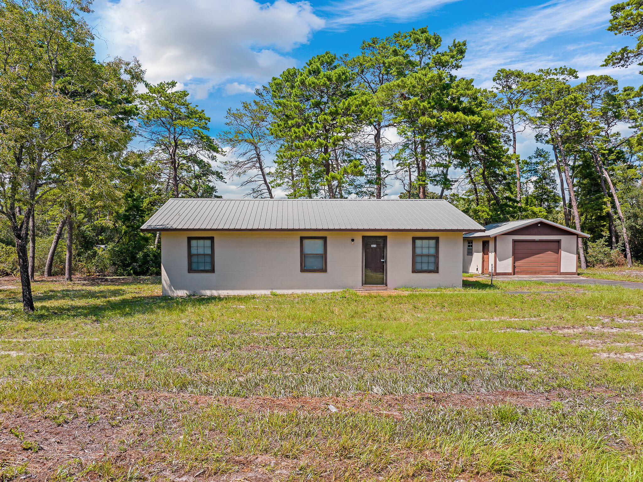 323 Pinewood Lane Inlet Beach, FL 32461 - Photo 16 of 50 a view of a yard in front of a house with large trees