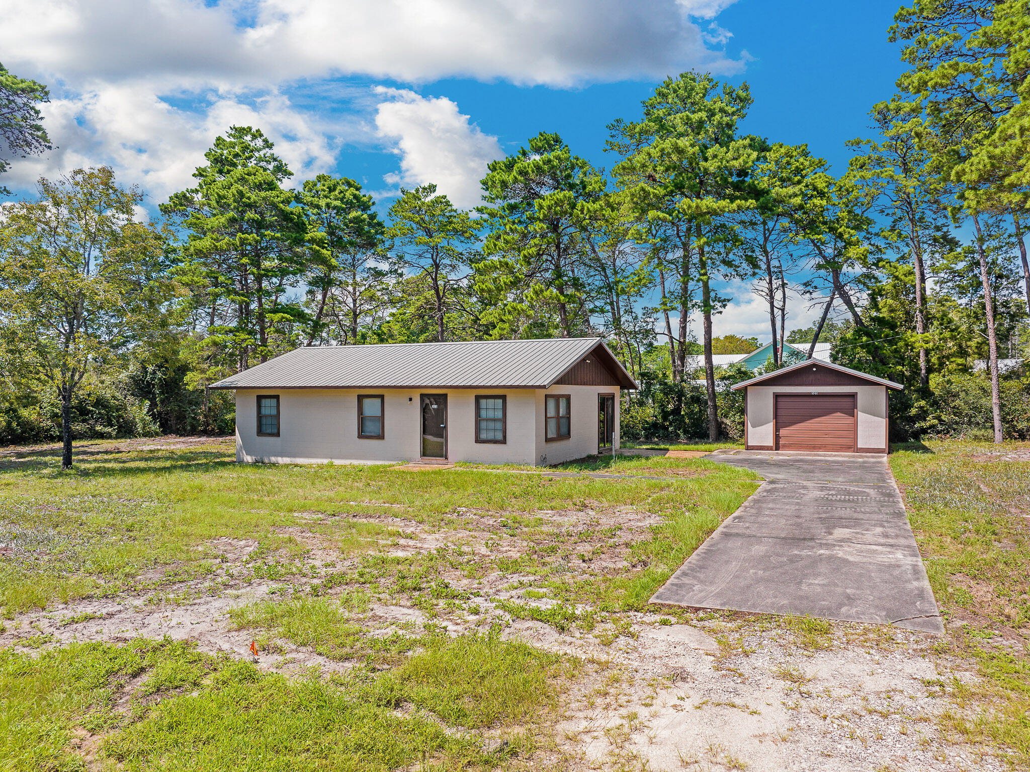 323 Pinewood Lane Inlet Beach, FL 32461 - Photo 18 of 50 a front view of a house with a garden