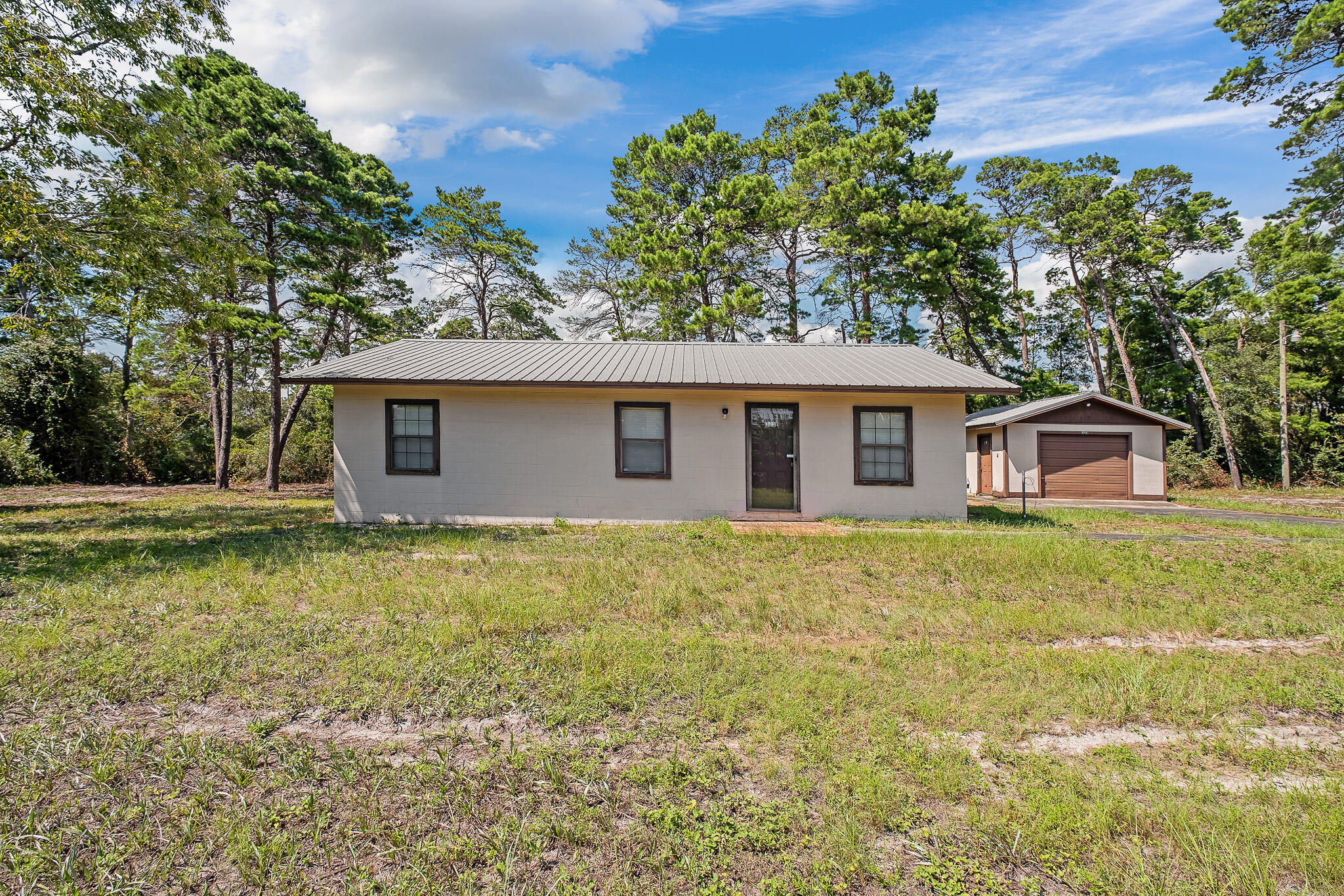 323 Pinewood Lane Inlet Beach, FL 32461 - Photo 2 of 50 a front view of a house with a garden