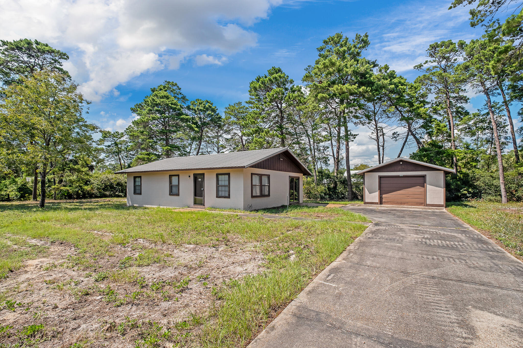 323 Pinewood Lane Inlet Beach, FL 32461 - Photo 3 of 50 a front view of a house with a garden