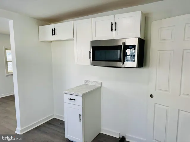a kitchen with cabinets stainless steel appliances and a counter space