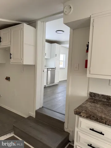 a kitchen with cabinets appliances and a counter space