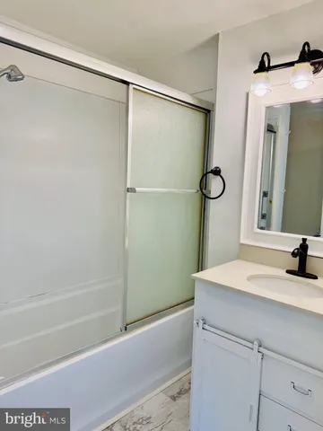 a bathroom with a shower and a sink