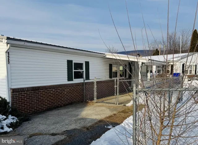 a view of a patio with wooden fence