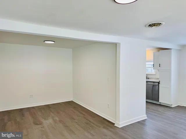 a view of a kitchen with a sink and a refrigerator
