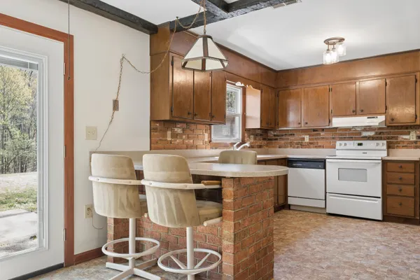 a kitchen with cabinets a sink and appliances