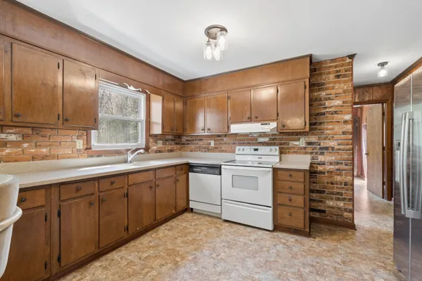 a kitchen with sink cabinets and window