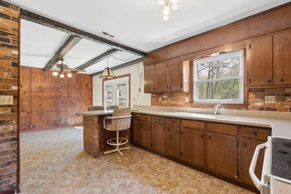 a kitchen with a sink cabinets and window