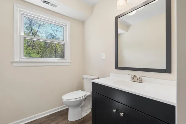 a white toilet sitting next to a bathroom sink