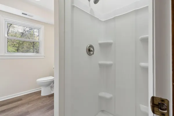 a view of a room with fridge and front door