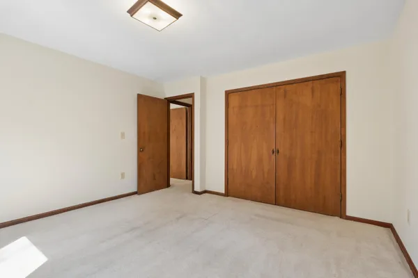 an empty room with a window and a ceiling fan