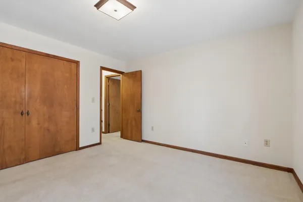 an empty room with closet area