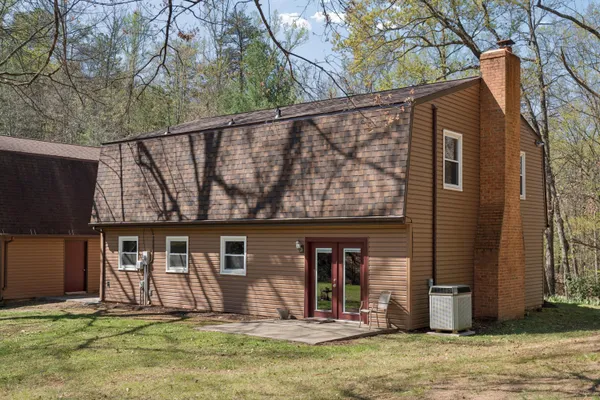 a view of a house with a yard and garage