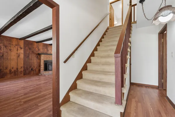 a view of staircase with white walls and a window