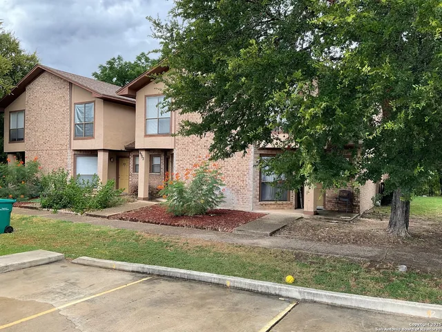 a front view of a house with a yard and a garage
