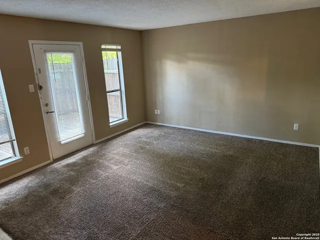 a view of empty room with a fireplace