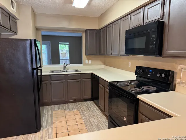 a kitchen with a sink stove and microwave