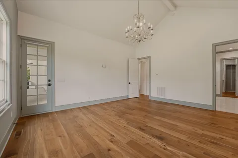 a view of a room with wooden floor