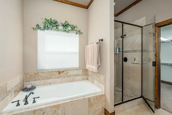 a bathroom with a bathtub and shower