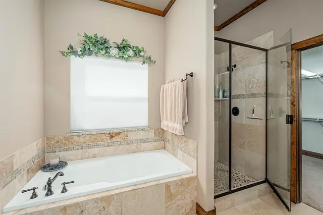 a bathroom with a bathtub and shower