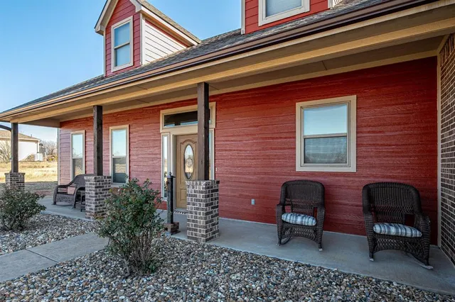a front view of a house with outdoor seating