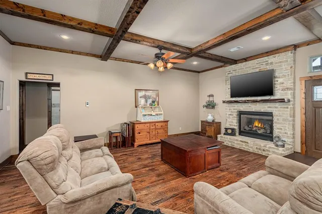 a living room with furniture a flat screen tv and a fireplace