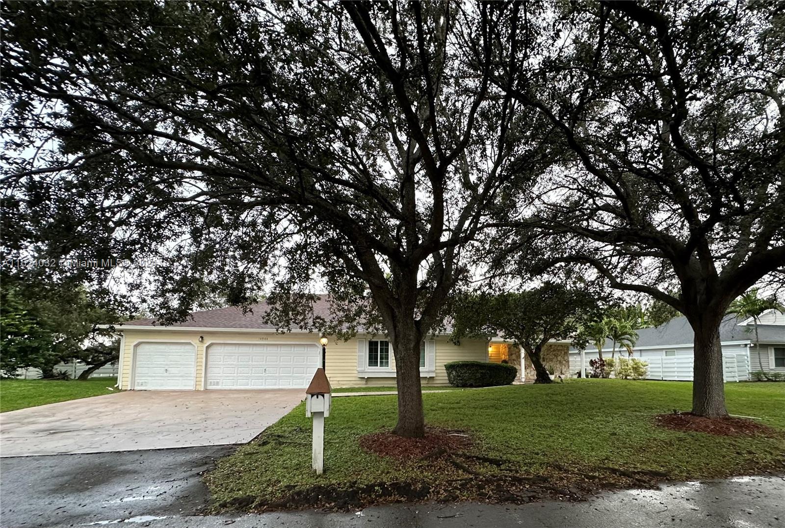 14944 Southwest 144th Court Miami, FL 33186 - Photo 1 of 34 a front view of a house with a yard and trees