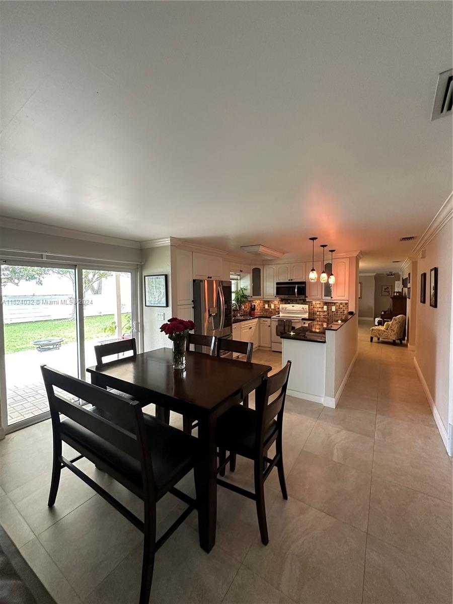 14944 Southwest 144th Court Miami, FL 33186 - Photo 12 of 34 a view of a dining room with furniture and a large window