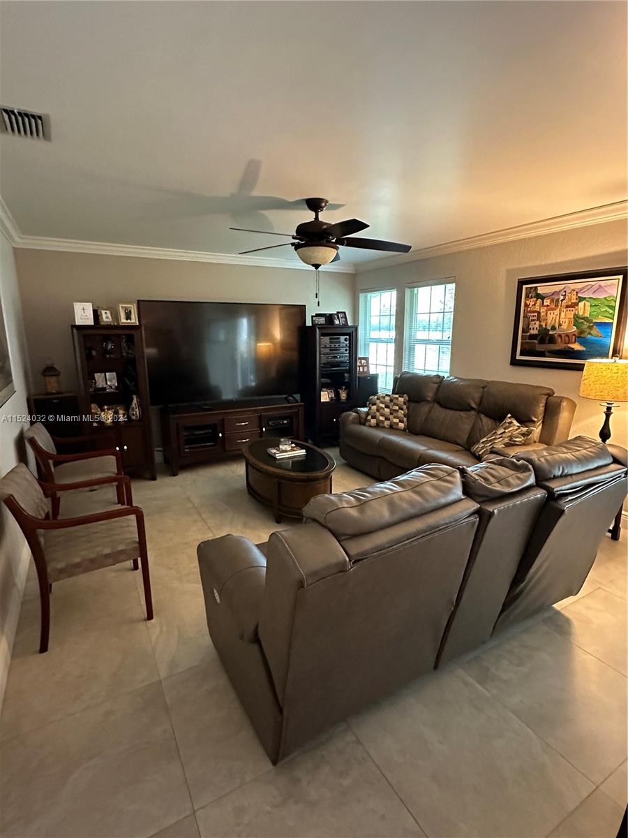 14944 Southwest 144th Court Miami, FL 33186 - Photo 14 of 34 a living room with furniture and a flat screen tv