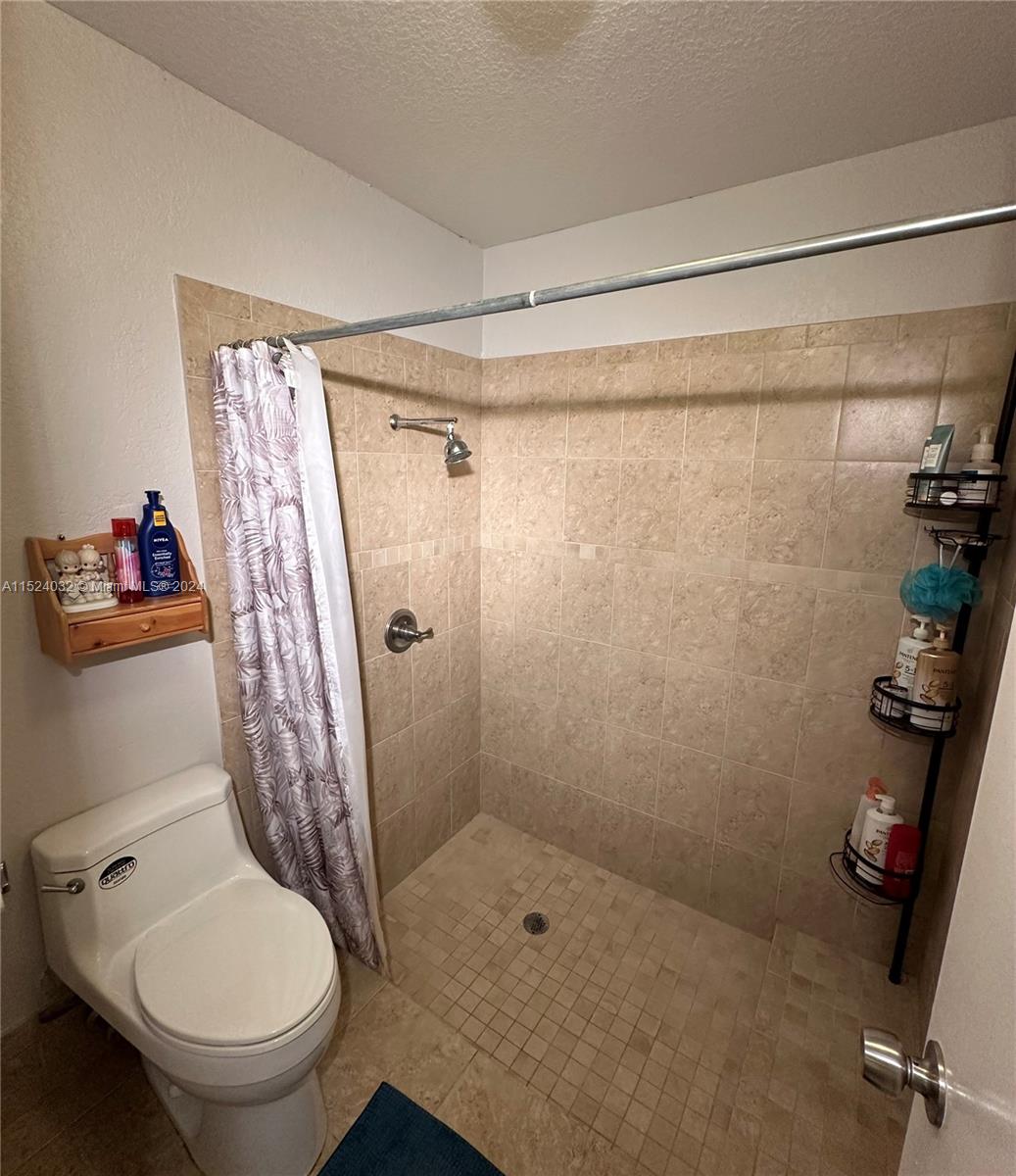 14944 Southwest 144th Court Miami, FL 33186 - Photo 17 of 34 a bathroom with a toilet and a shower