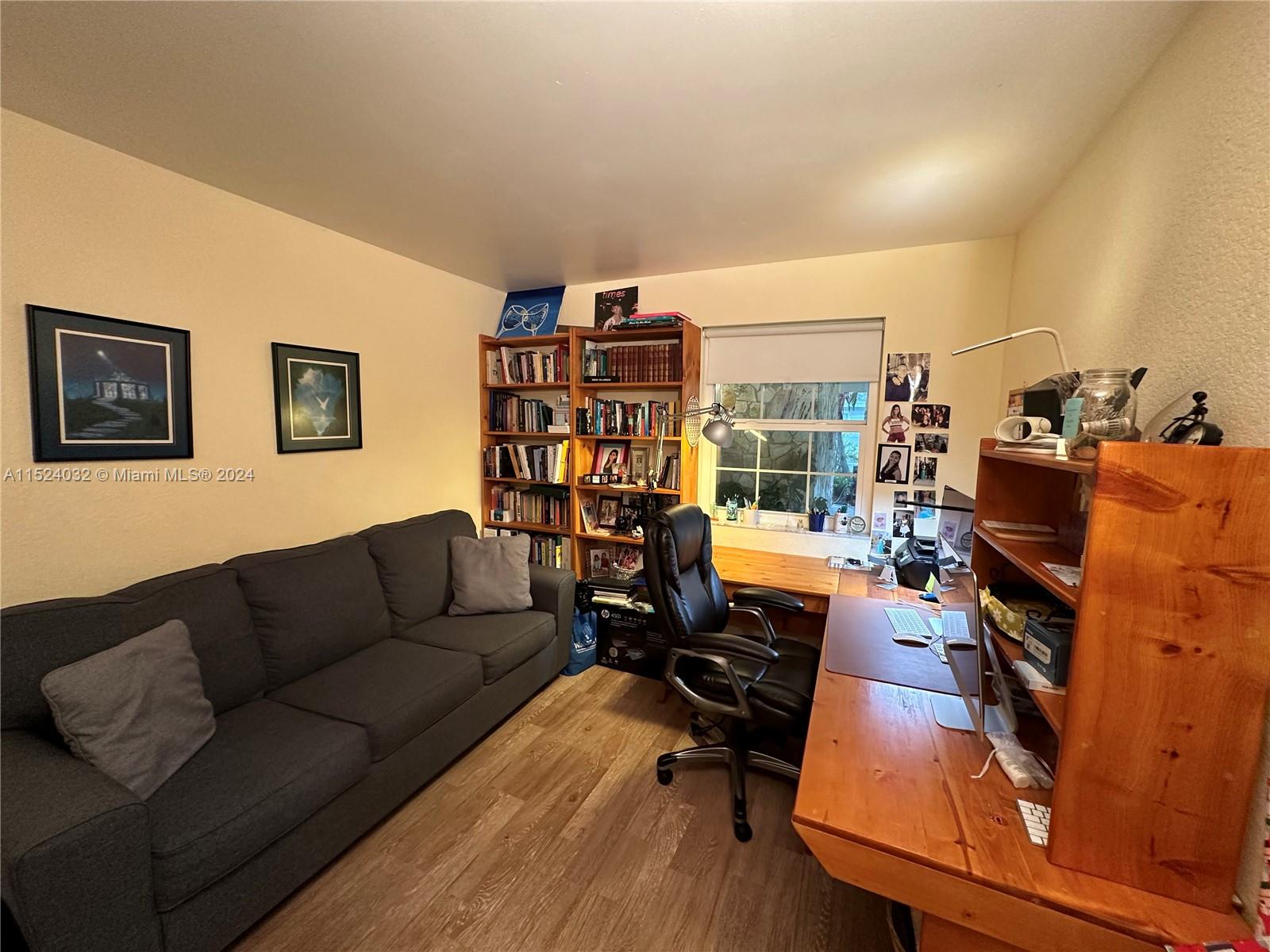 14944 Southwest 144th Court Miami, FL 33186 - Photo 23 of 34 a living room with furniture and a floor to ceiling window