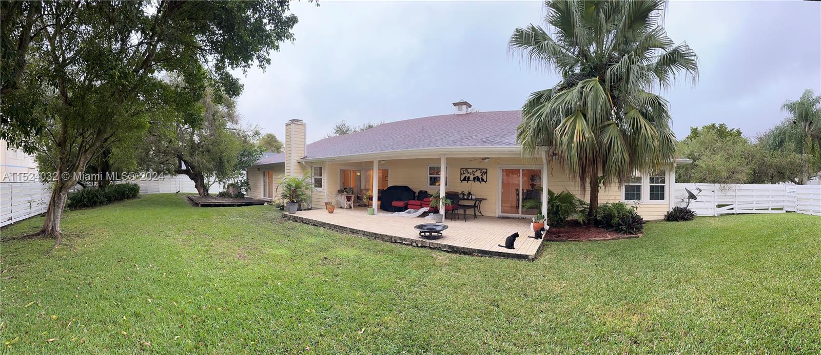14944 Southwest 144th Court Miami, FL 33186 - Photo 26 of 34 a view of a house with backyard porch and sitting area
