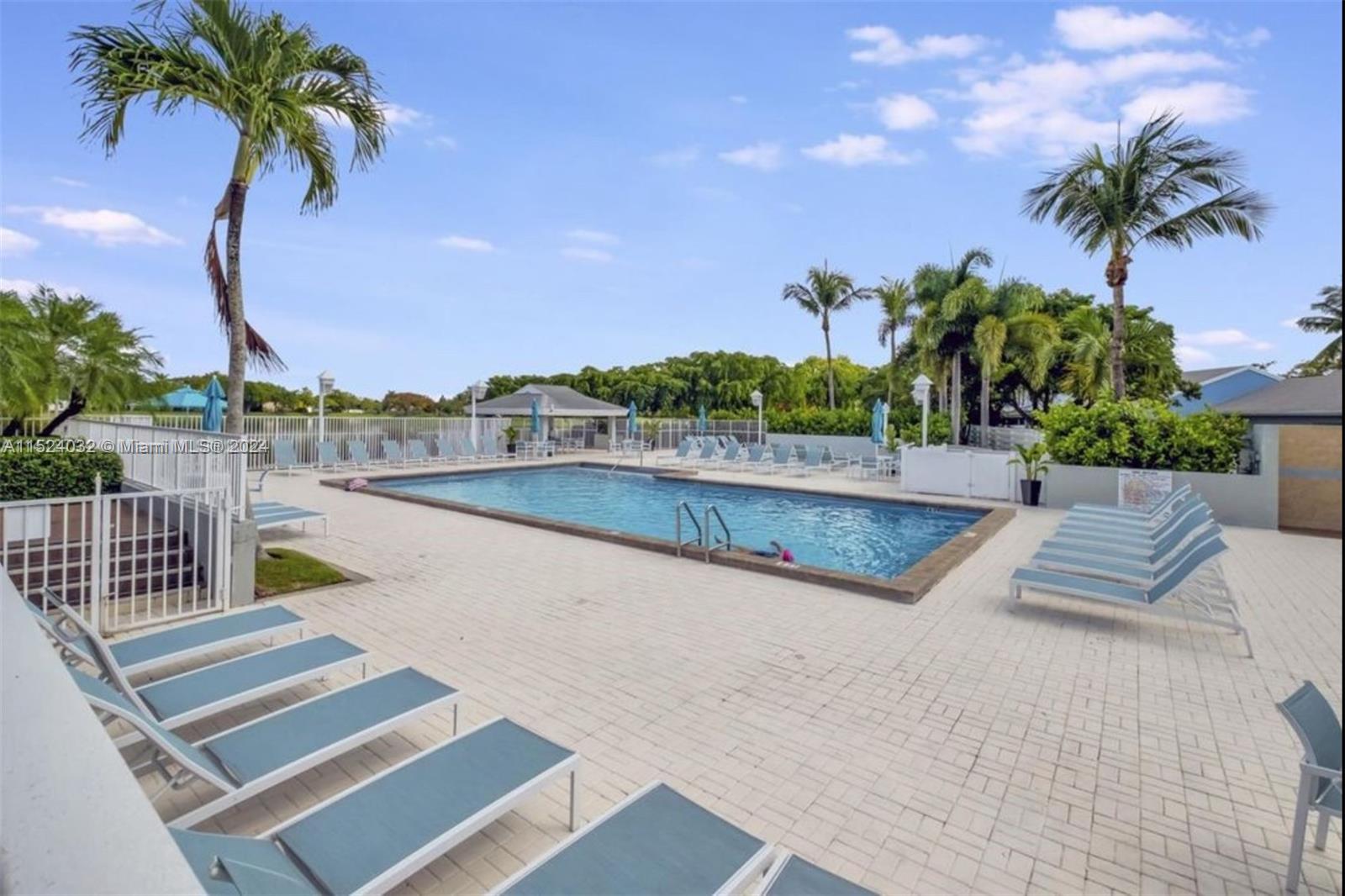 14944 Southwest 144th Court Miami, FL 33186 - Photo 30 of 34 a view of swimming pool with a table and chairs