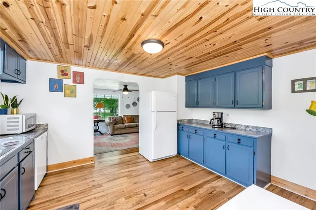 a kitchen with refrigerator and cabinets