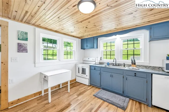 a kitchen with a sink cabinets and window