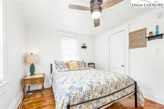 a bedroom with a bed and ceiling fan