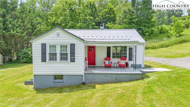 a view of a house with swimming pool and porch with furniture