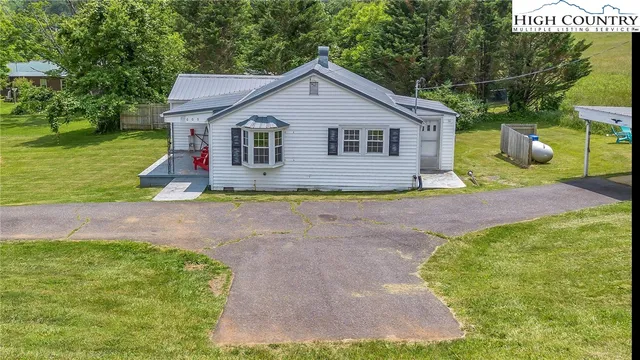 a view of backyard of house with green space