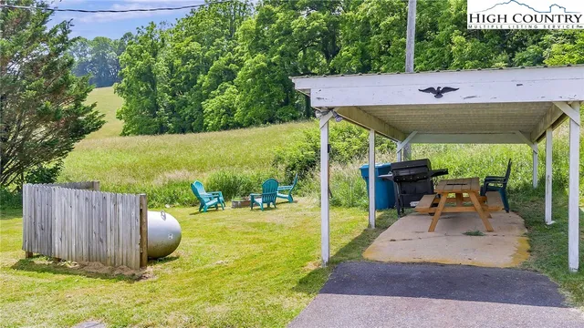 a view of a backyard with sitting area