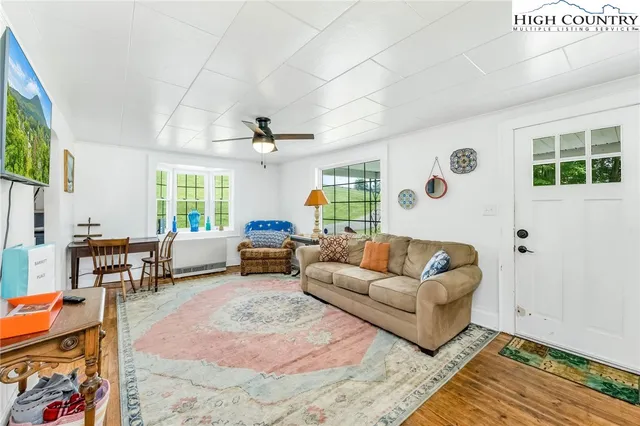 a living room with furniture and a large window