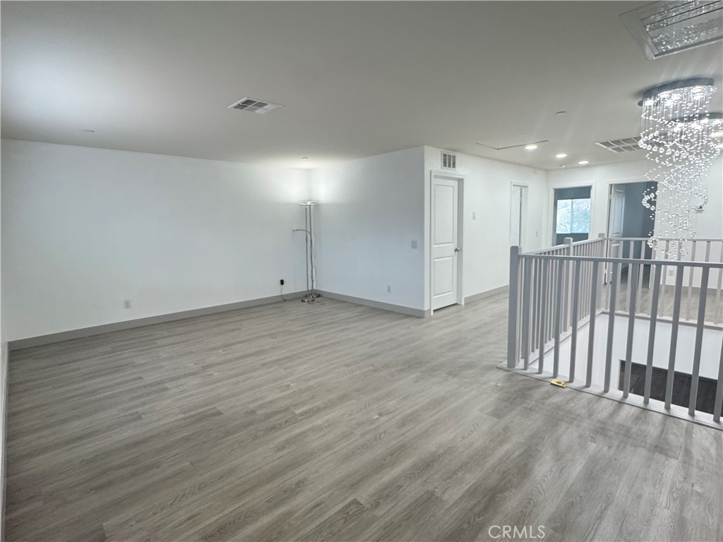 11742 Connell Road Riverside, CA 92505 - Photo 23 of 50 an empty room with wooden floor and windows