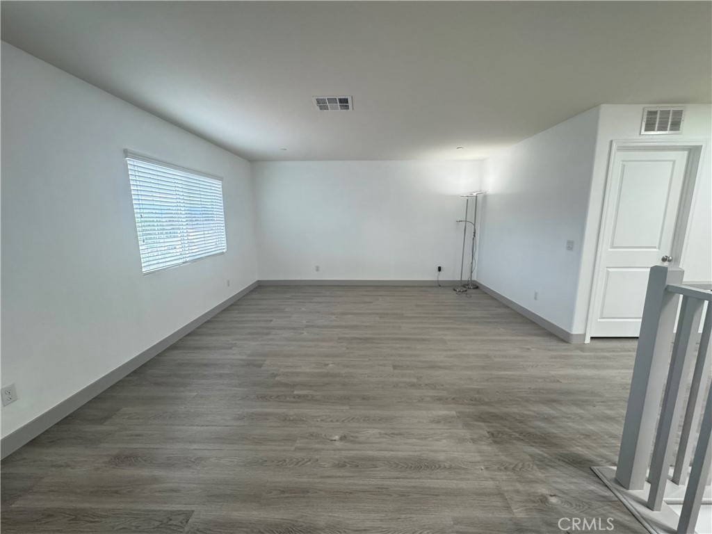 11742 Connell Road Riverside, CA 92505 - Photo 24 of 50 an empty room with wooden floor and window