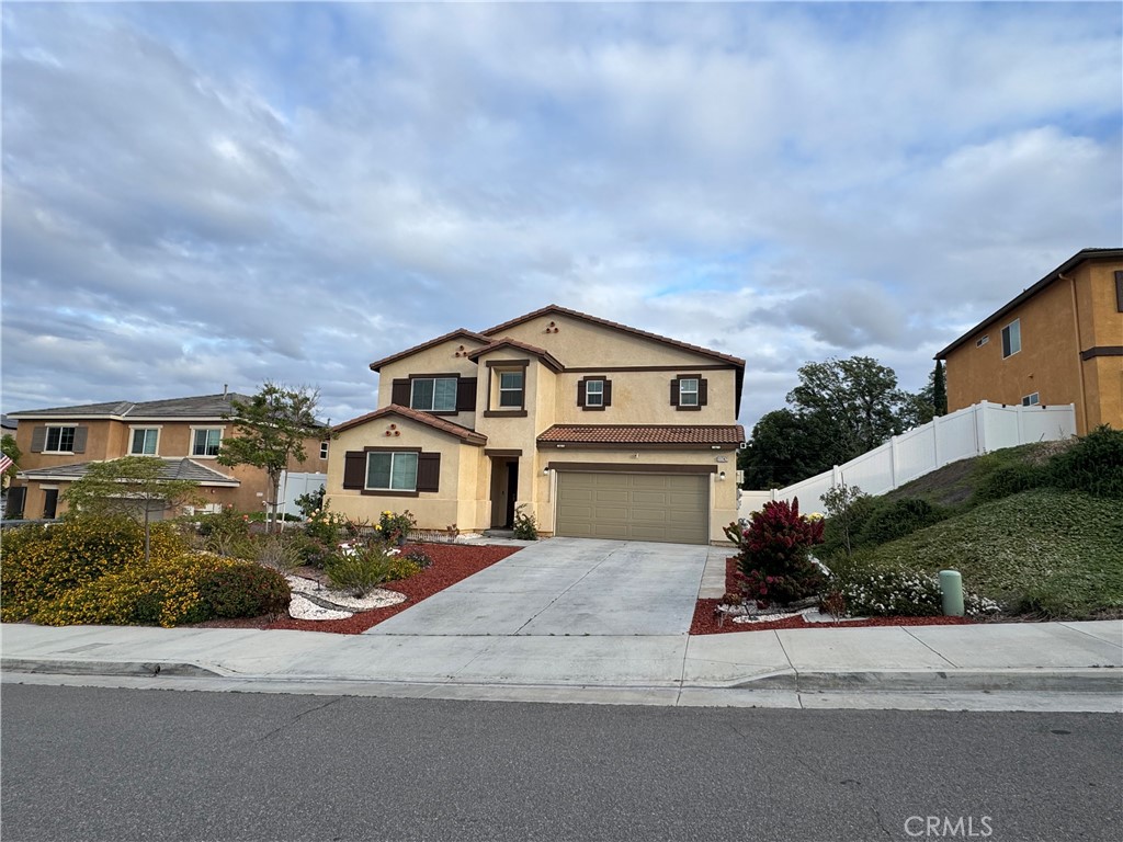 11742 Connell Road Riverside, CA 92505 - Photo 48 of 50 a front view of a house with a yard and garage