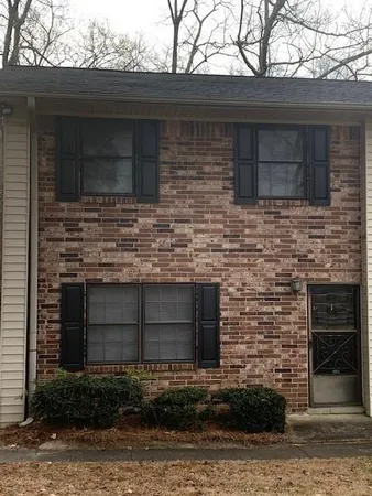 a brick building with a small yard