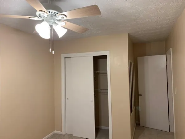 a view of a chandelier fan and a closet
