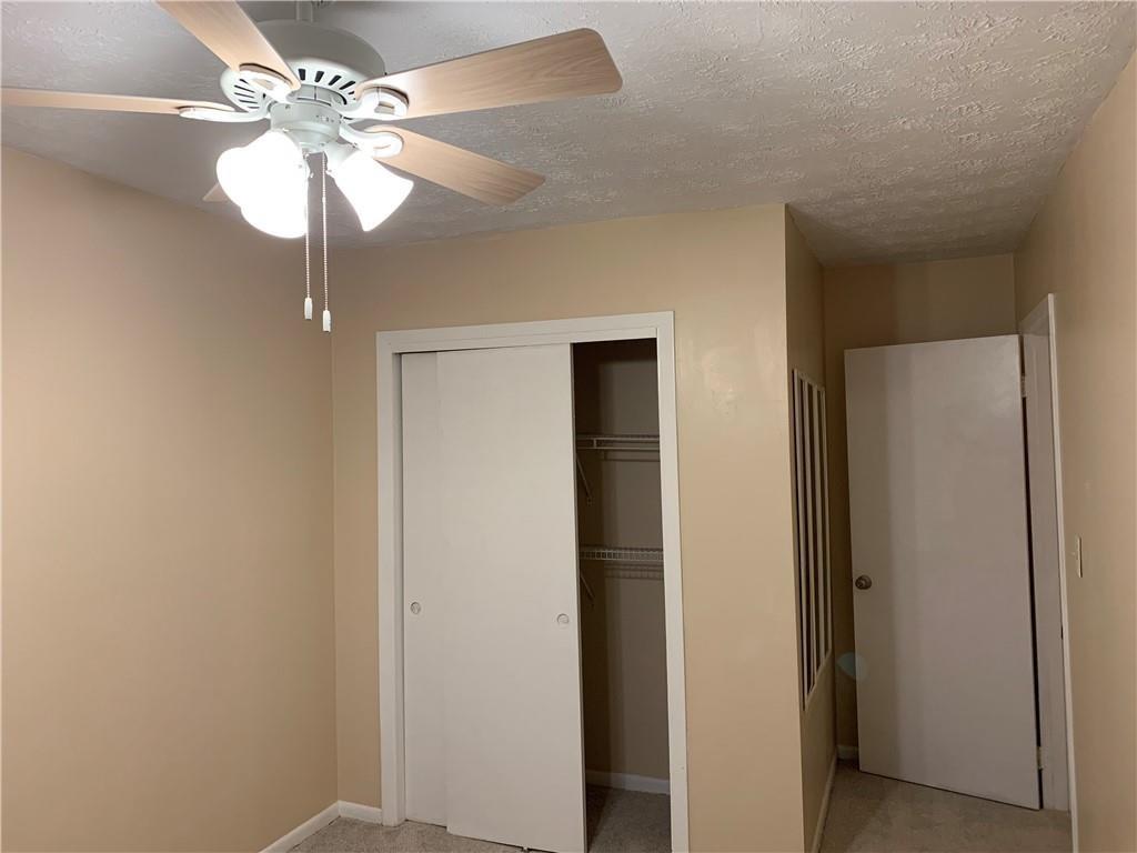 1235 Riverside Drive, Unit H1 Gainesville, GA 30501 - Photo 17 of 19 a view of a chandelier fan and a closet