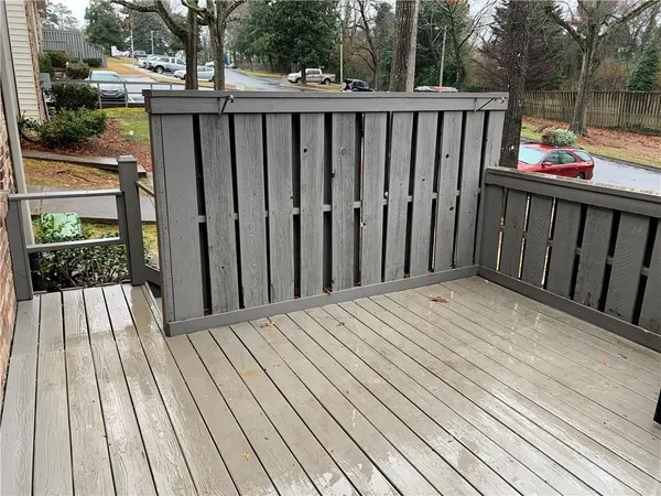 a view of backyard with deck and wooden floor