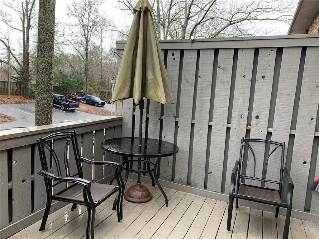 1235 Riverside Drive, Unit H1 Gainesville, GA 30501 - Photo 4 of 19 a view of balcony with furniture and wooden floor