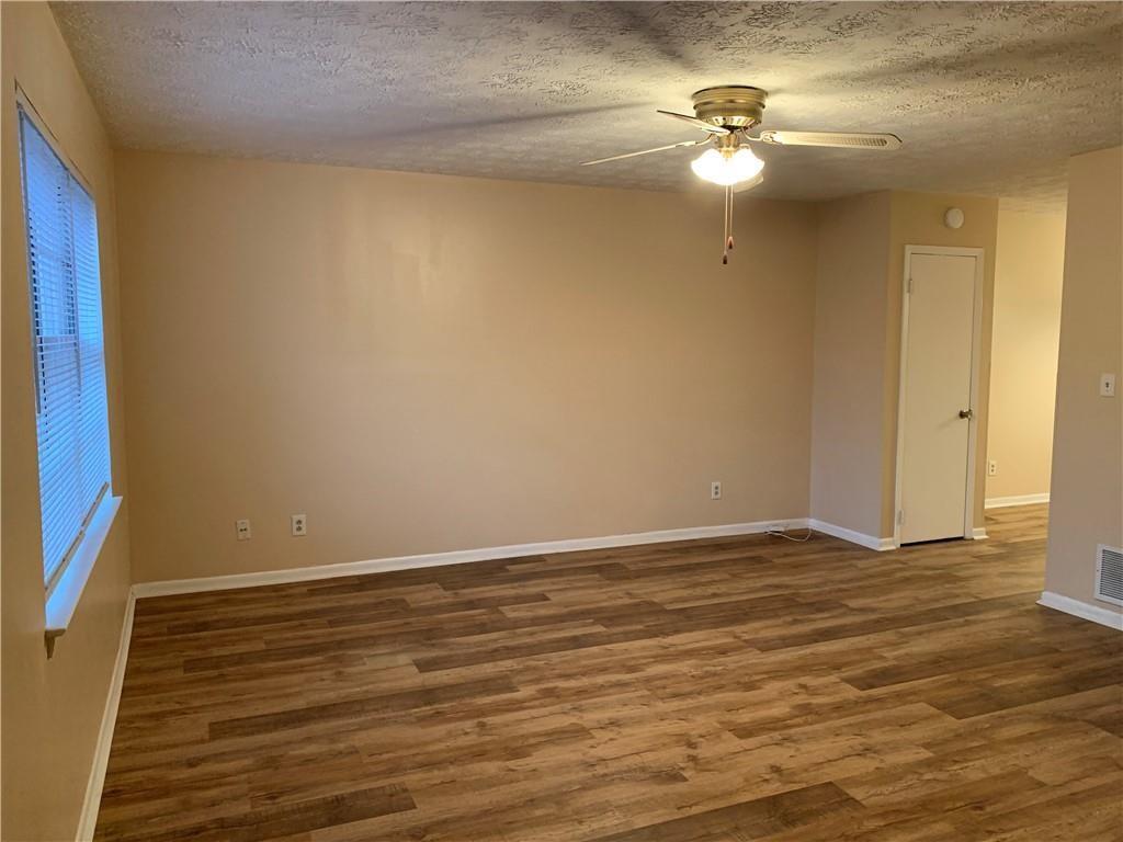 1235 Riverside Drive, Unit H1 Gainesville, GA 30501 - Photo 9 of 19 a view of an empty room with wooden floor