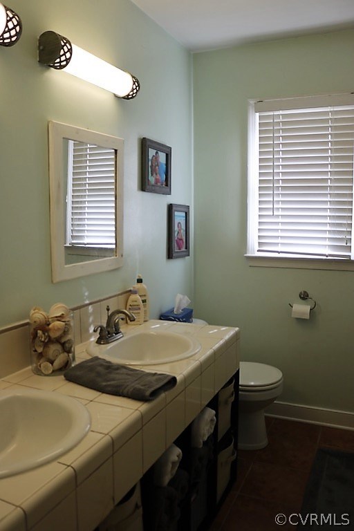 7211 Full Rack Drive Midlothian, VA 23112 - Photo 11 of 22 a bathroom with a sink a toilet and a window